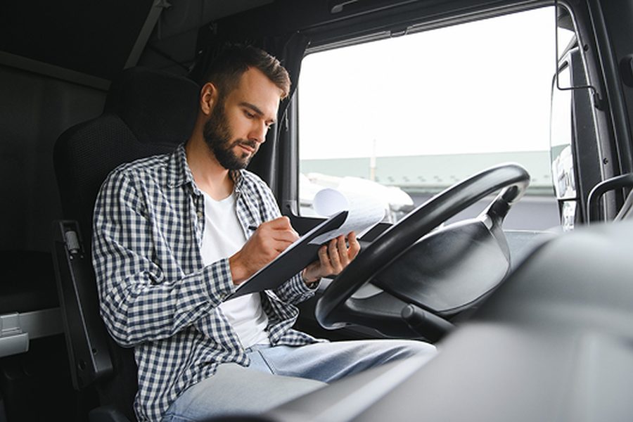 Owner-operator reviewing a rate confirmation on a tablet in the cab